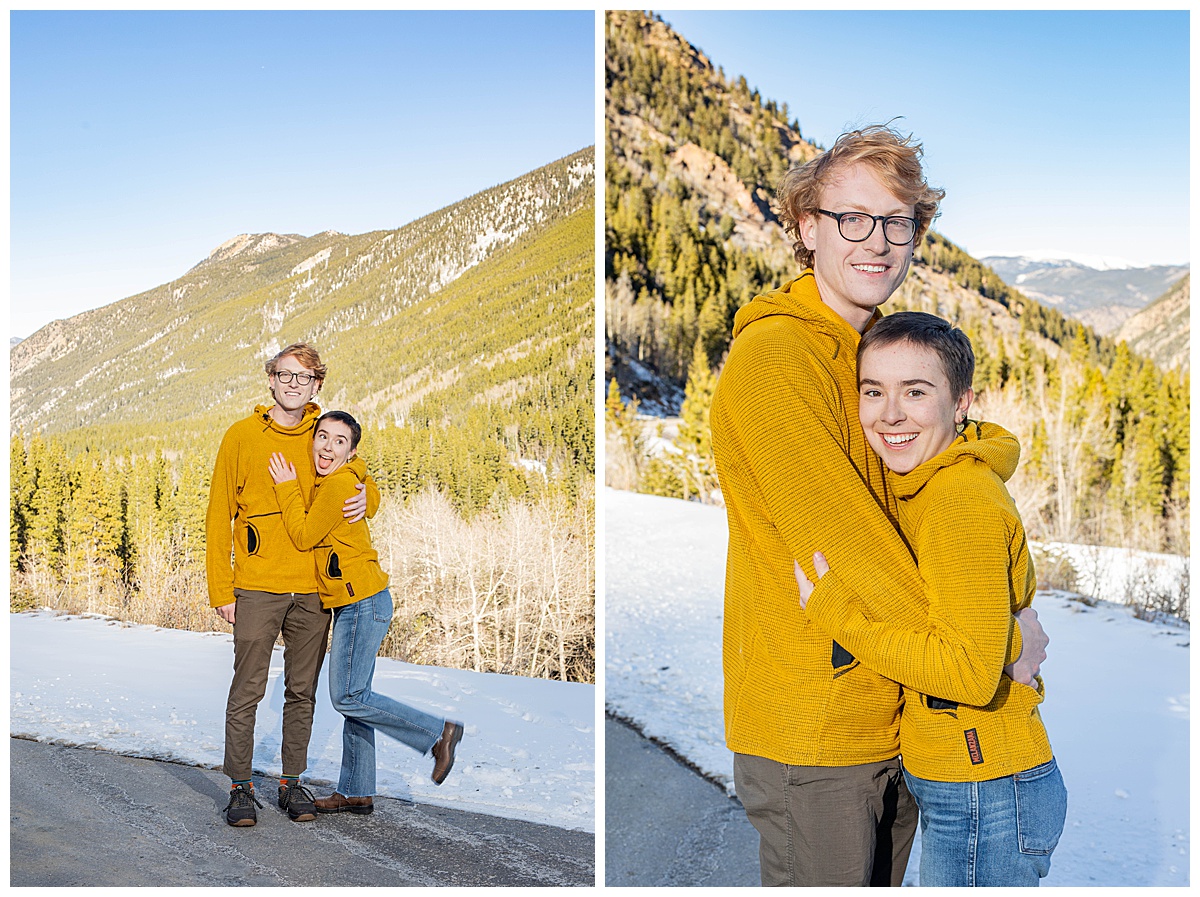 A couple in yellow poses in front of snow and pine trees for couple portraits.