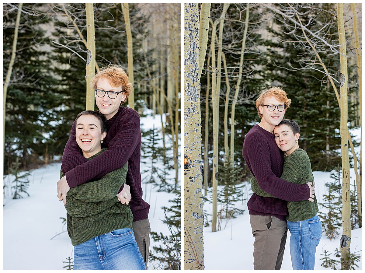 A couple poses in front of snow and aspen trees for couple portraits.