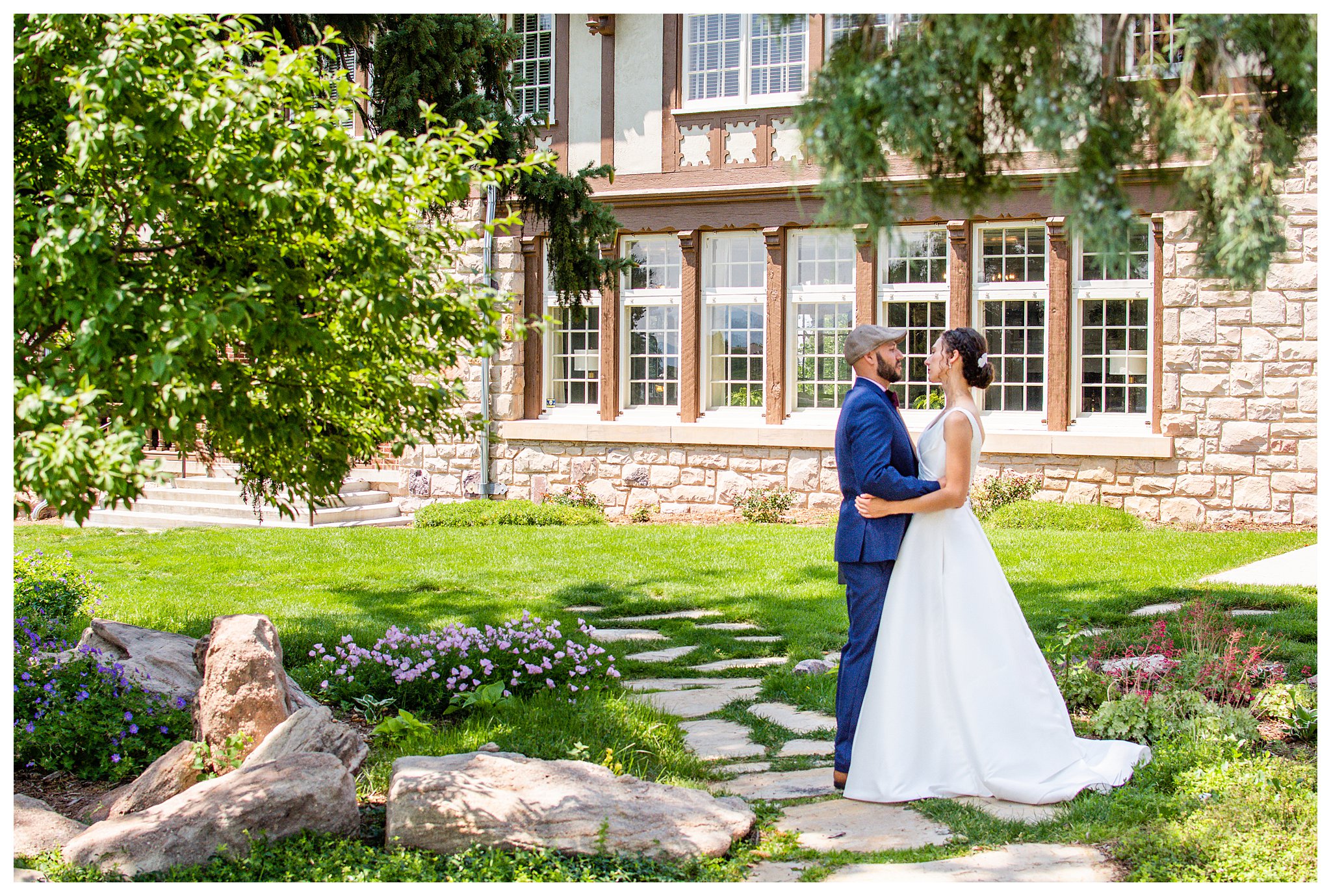 A bride and groom pose for bridal photos before their mansion wedding