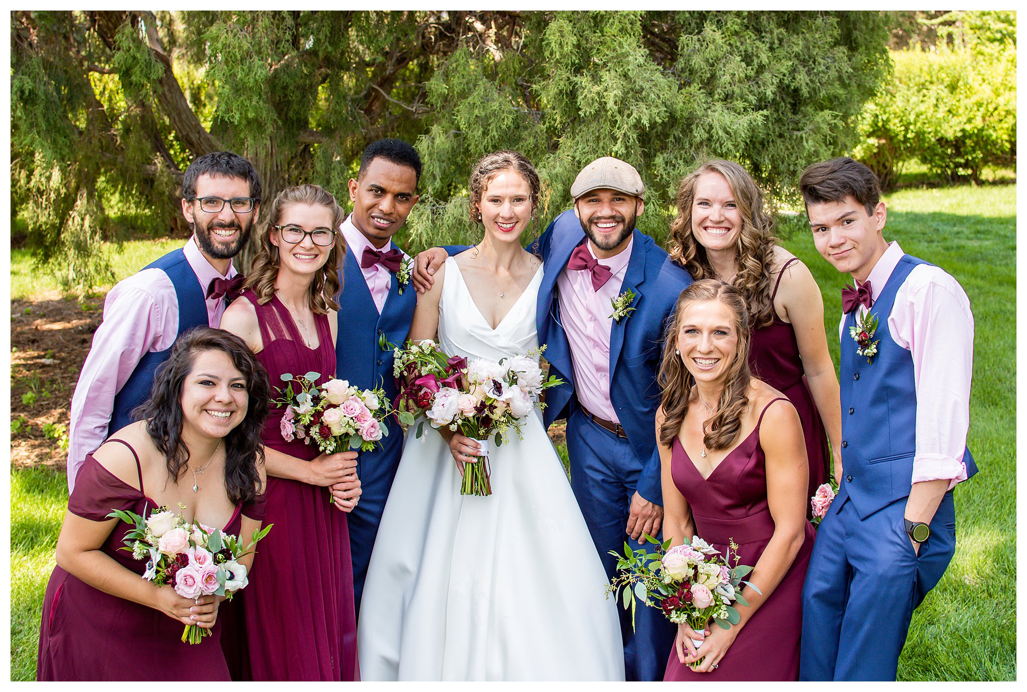 A bride and groom pose with their bridal party