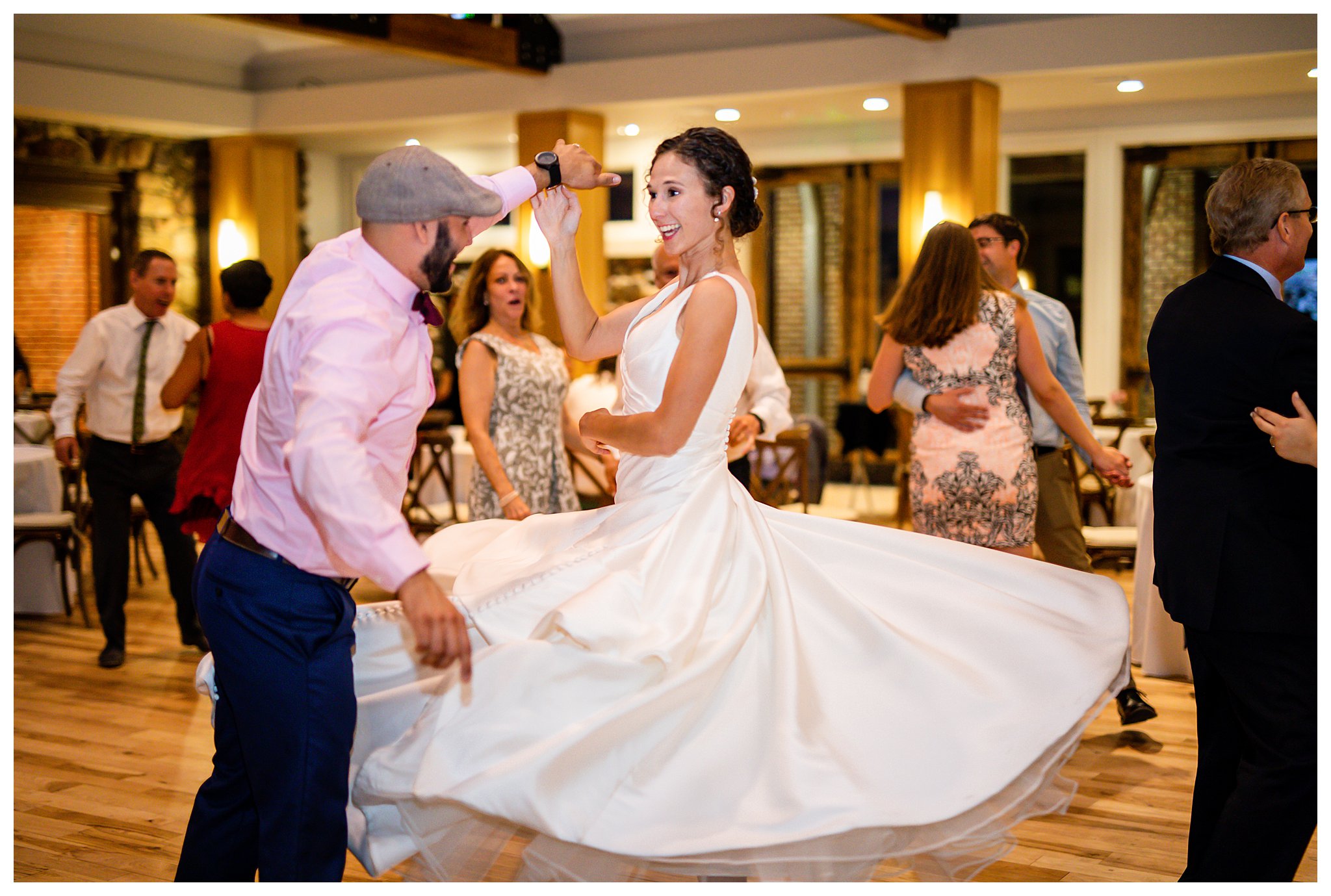 A couple has their first dance in front of their guests