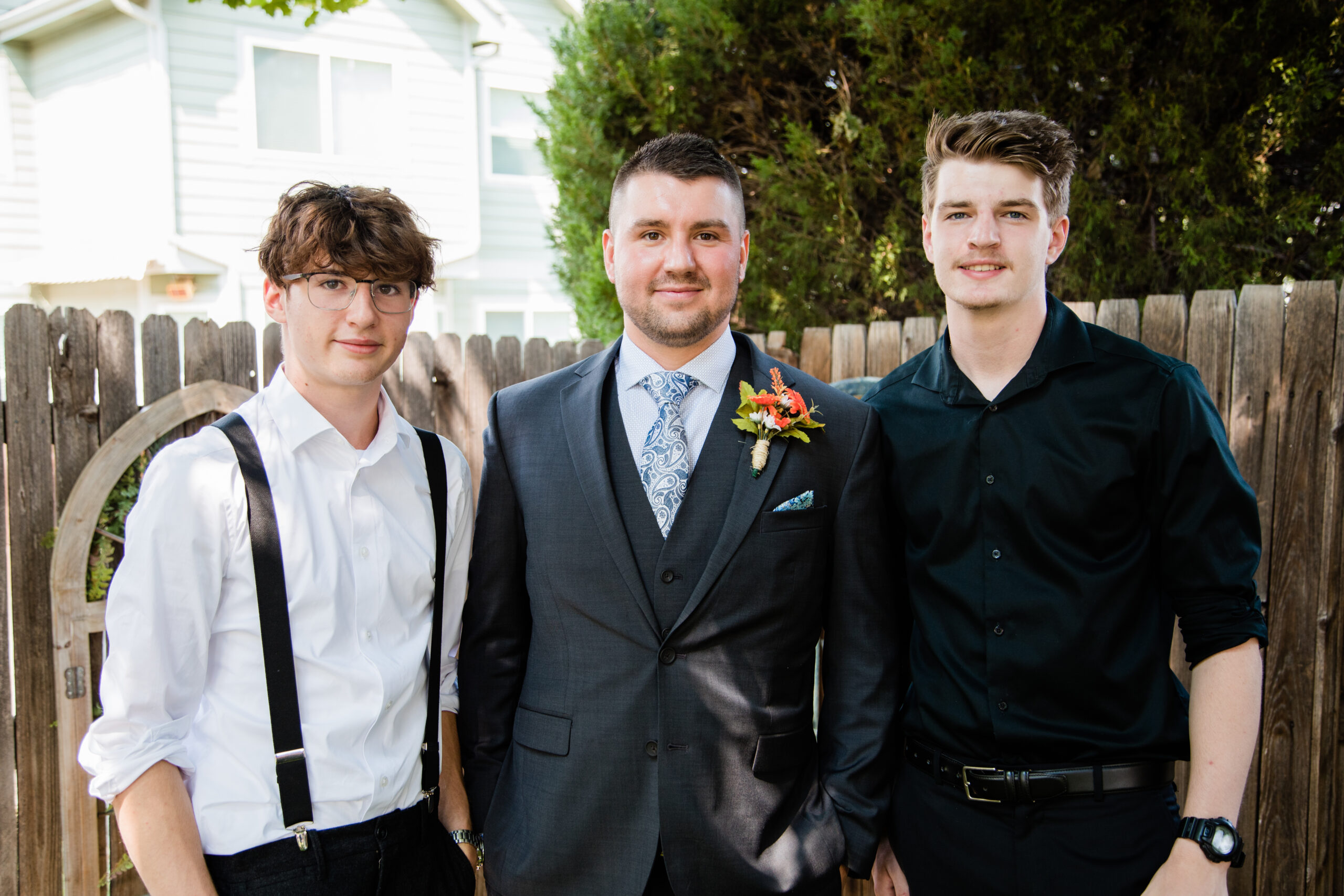A groom poses with his brothers after his wedding ceremony.