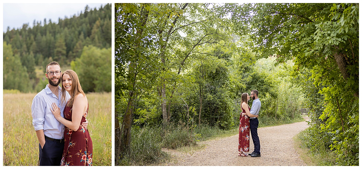 A couple poses amongst trees for a couples session. The woman is wearing a long red dress and the man is wearing a light blue button up and dark navy pants.