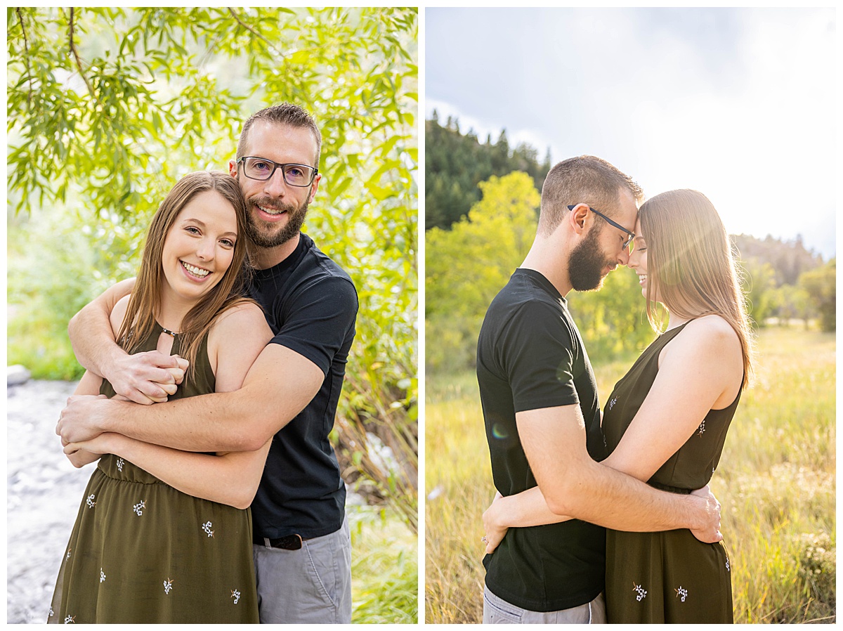 A couple poses amongst trees for a couples session. The woman is wearing a short olive green dress and the man is wearing a black t-shirt and gray shorts.