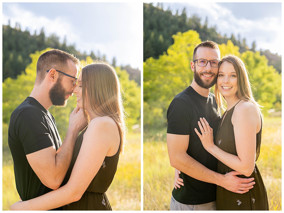 A couple poses amongst trees for a fall engagement session. The woman is wearing a short olive green dress and the man is wearing a black t-shirt and gray shorts.