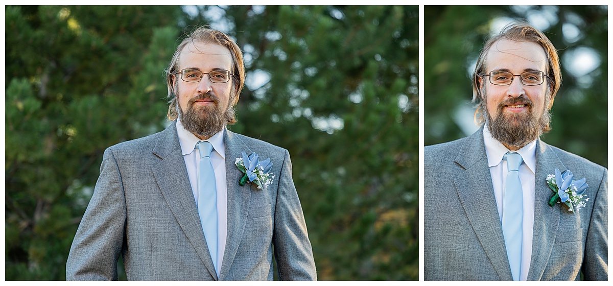 The groom poses in front of trees for his portraits