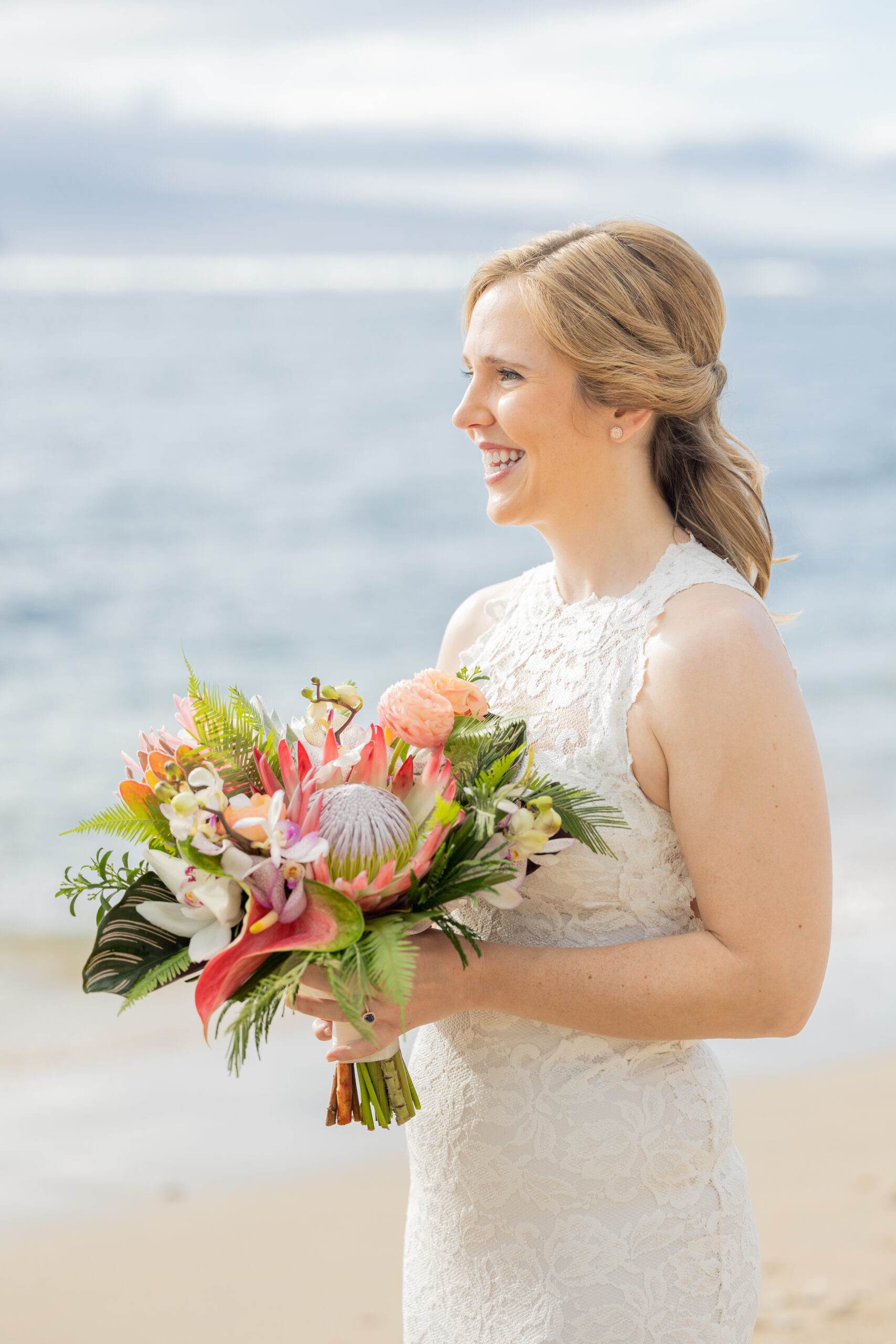 A bride sees her bride for the first time. They are getting married on the beach in front of the ocean.