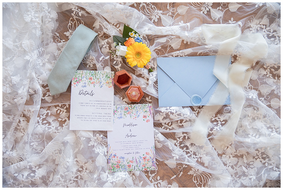 An invitation suite with wildflowers, blue, and yellow colors perfectly compliments this spring wedding inspiration shoot.