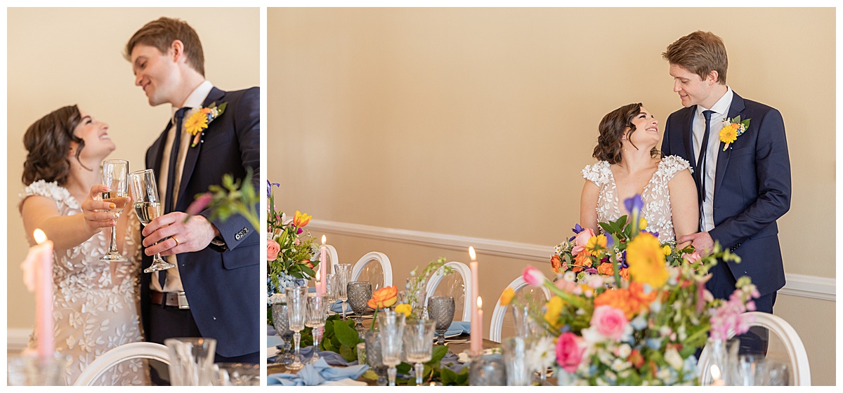 A bride and groom pose in front of their wedding table covered in colorful wildflowers in this spring wedding inspiration shoot.