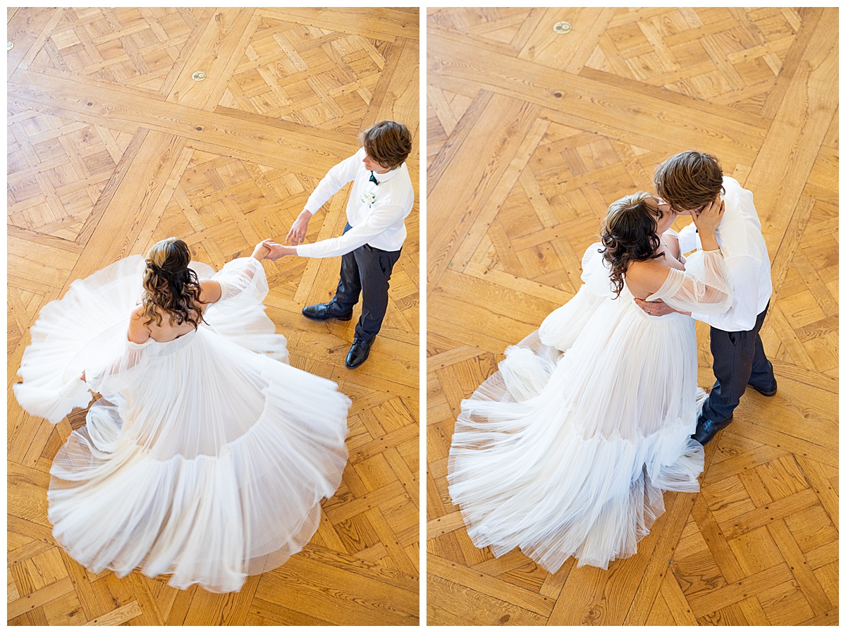 A man and woman dance on the dance floor. He spins her and her dress twirls around.