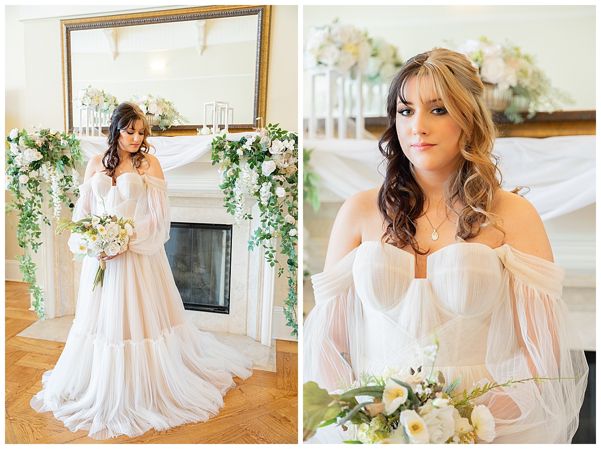 A bride poses in front of a white fireplace with greenery and white flowers all over it for a winter wedding inspiration shoot.