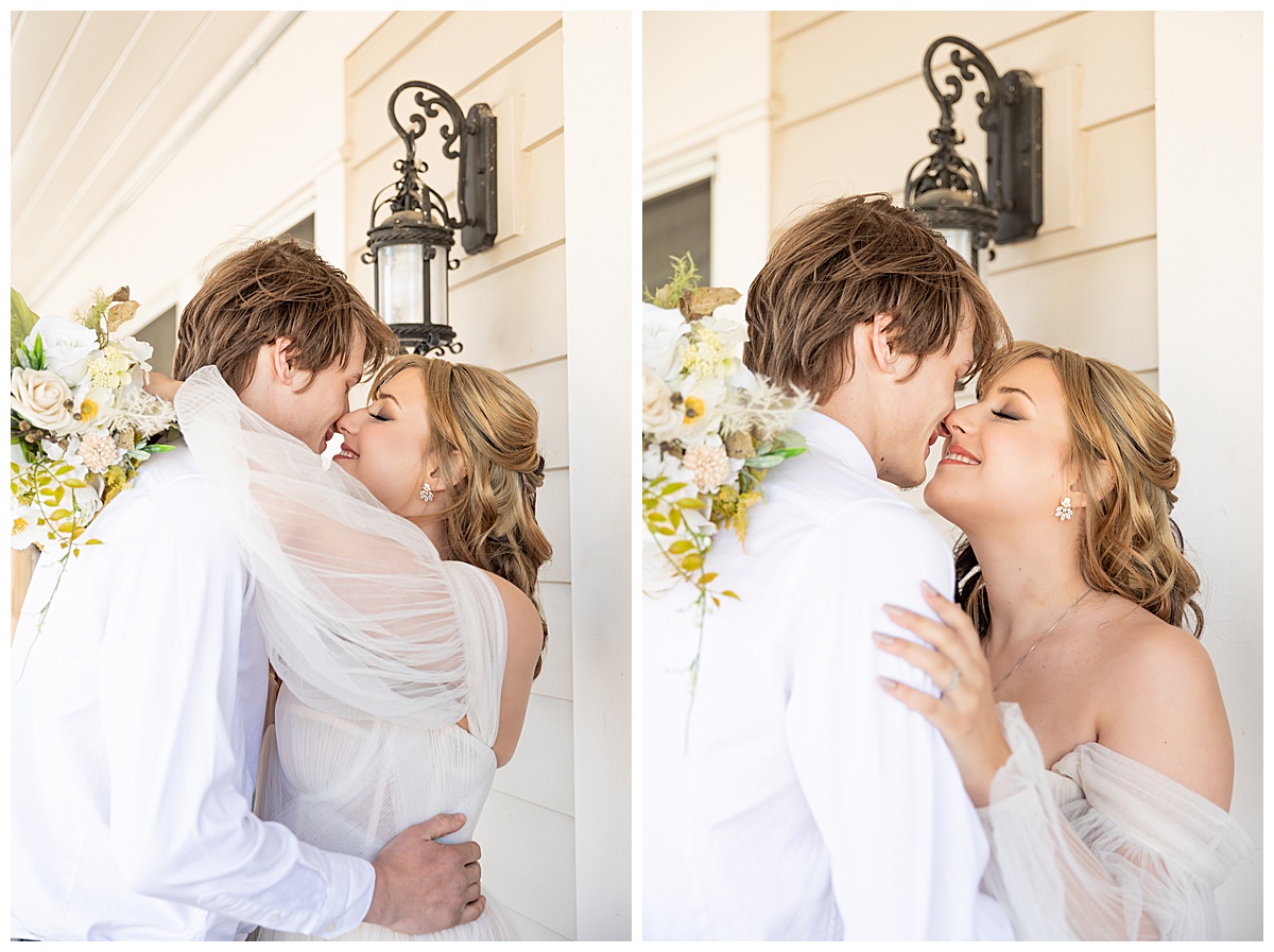 A bride and groom kiss and smile at each other outside on the porch of the mansion.
