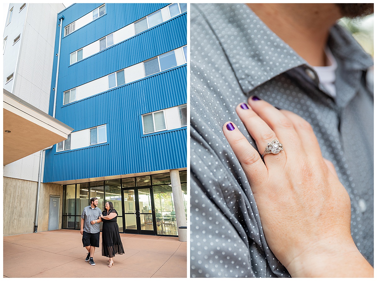 A couple in black and gray pose in front of a blue and concrete dorm building for their Auraria Campus engagement session