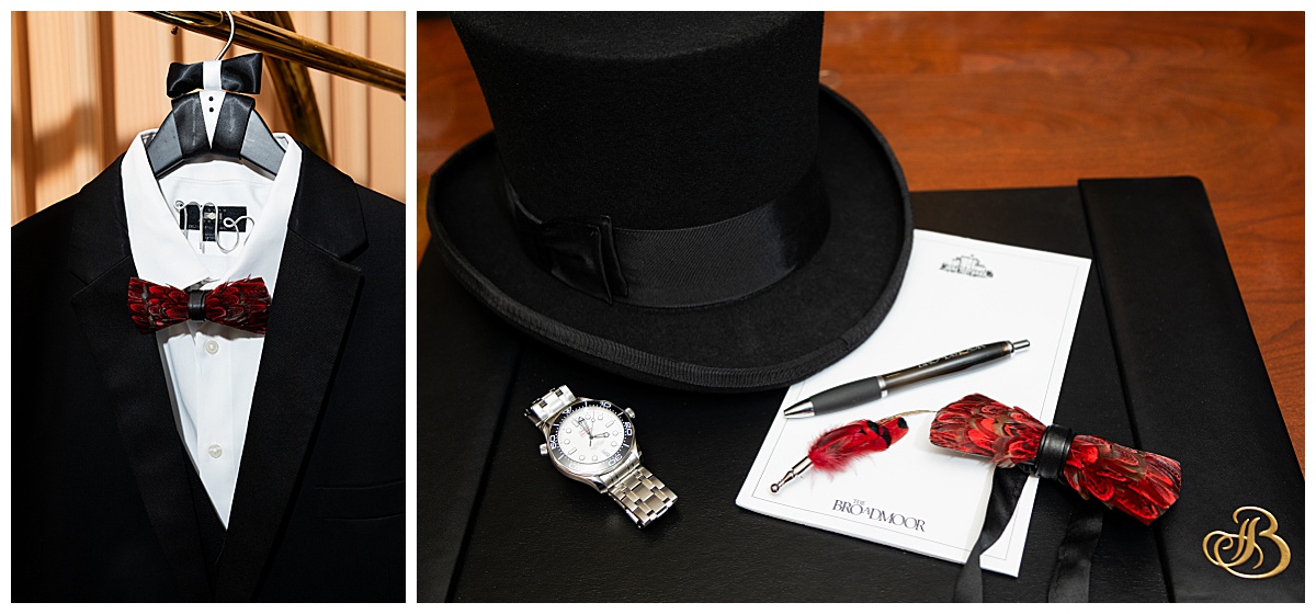 A close up of the groom's wedding details: his suit hanging on a "Mr" hanger, his red feather bowtie, his black top hat, his watch, and his feather hat pin. 