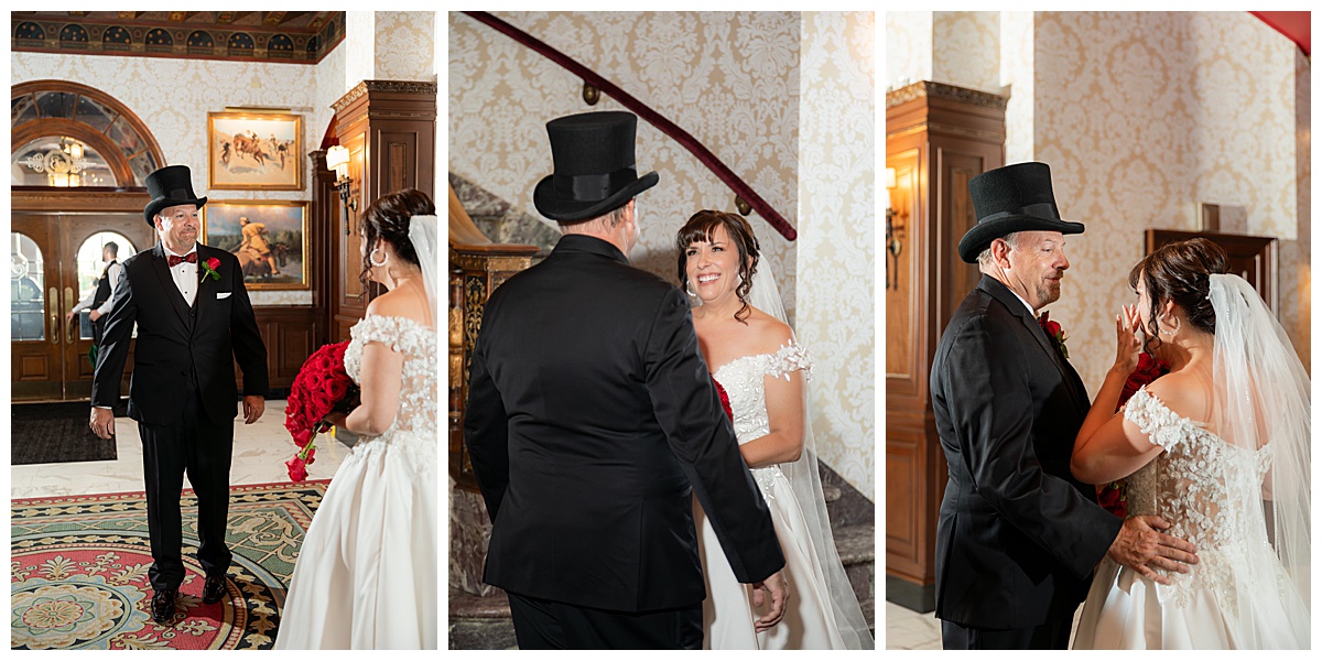 Photos of the first look between the bride and groom. He is wearing a black suit and black top hate. She is wearing a lace ballgown and long veil.
