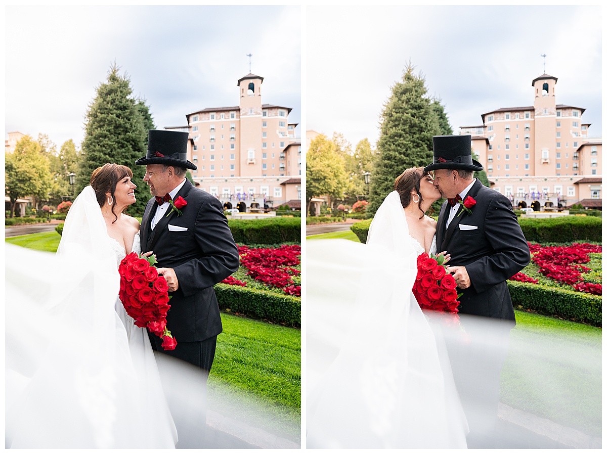 Couples portraits of a bride and groom during their Broadmoor wedding. The groom is wearing a black suit and black top hat. The bride is wearing a lace ballgown and a long veil.