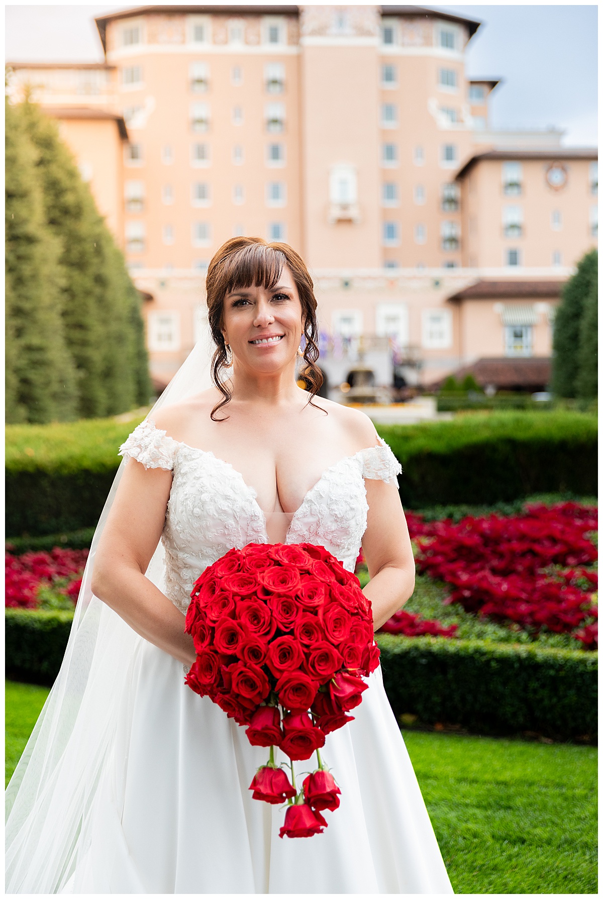 Portraits of a bride during her Broadmoor wedding. She is wearing a lace ballgown and a long veil.