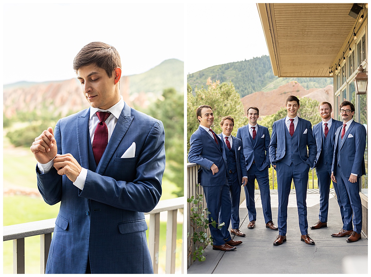 The groom is getting ready with his groomsmen. They are all wearing navy blue suits and maroon red ties.