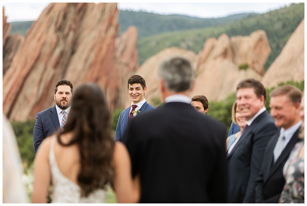 The groom is excited and tears up watching his bride walk down the aisle.