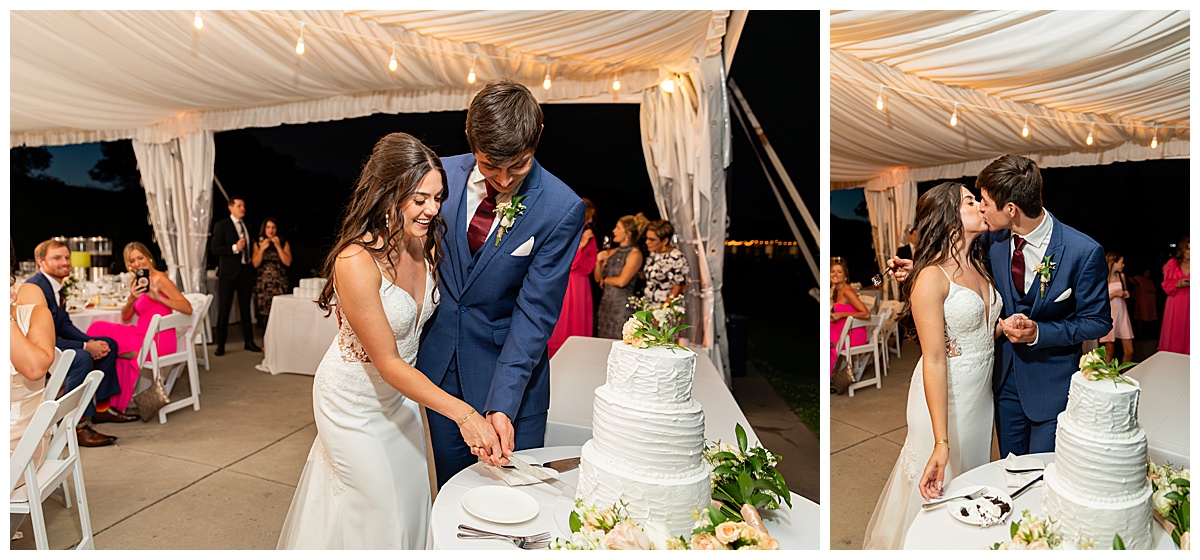 The bride and groom cut the cake and give each other a kiss. It is nighttime and they are under the reception tent.