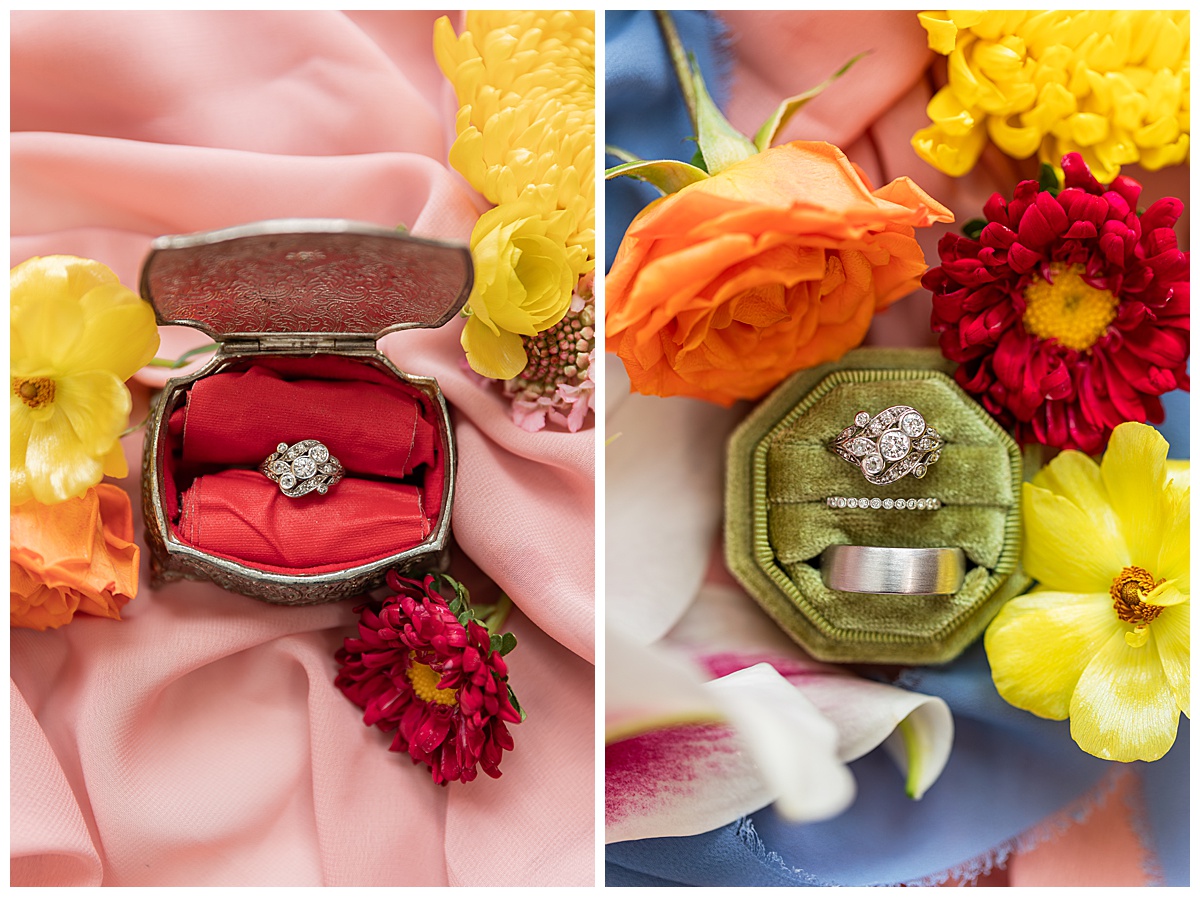 Two close-up pictures of the couple's wedding rings. The rings are in ring boxes surrounded by flowers and pink & blue fabric