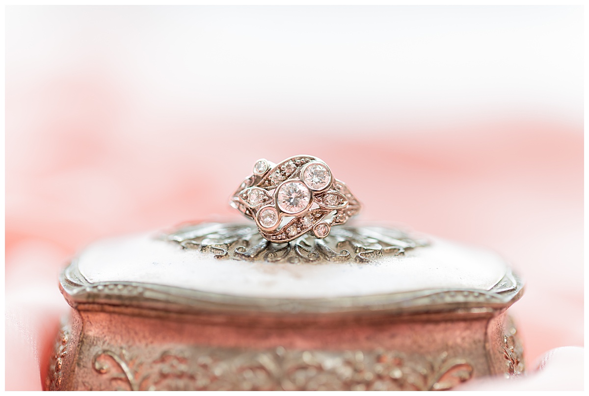 A close up of the bride's engagement ring. It is sitting on an antique ring box