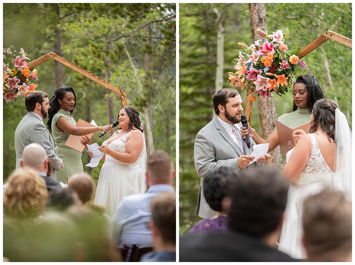 The bride and groom get married at Winter Park Mountain Lodge. They are reading their vows to each other. A heptagonal arch, pine trees, and a mountain are behind them.