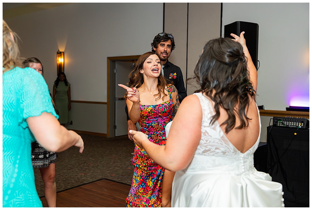 The couple dances the night away with their friends in the ballroom of the Winter Park Mountain Lodge. The dace floor is full and people are signing and dancing.