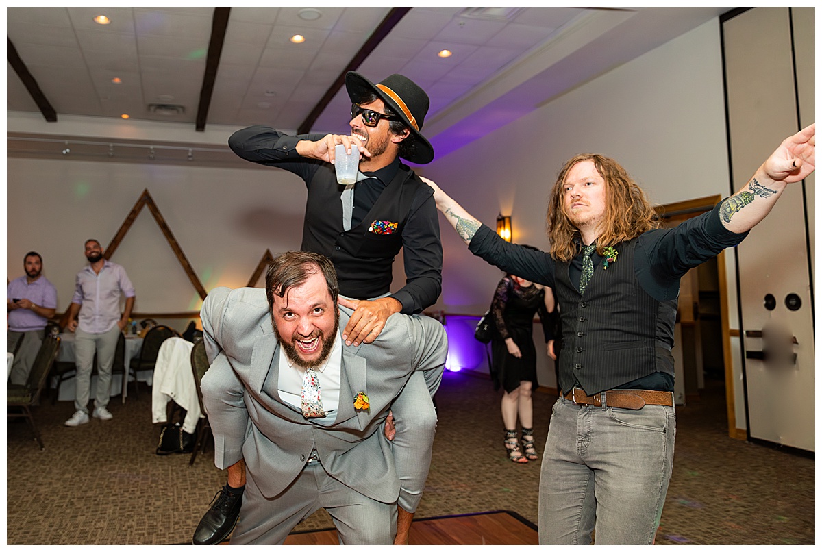 The couple dances the night away with their friends in the ballroom of the Winter Park Mountain Lodge. The dace floor is full and people are signing and dancing.