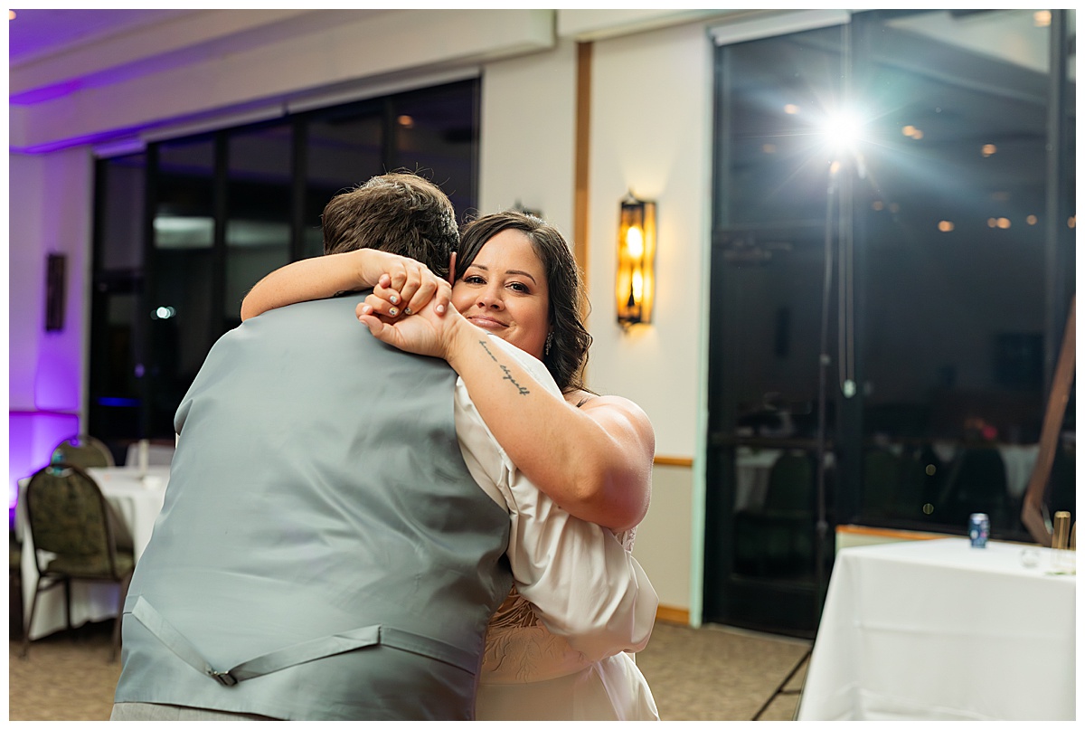 The couple shares their last dance in the ballroom of the Winter Park Mountain Lodge. There is no one else in the room and they have a private moment.