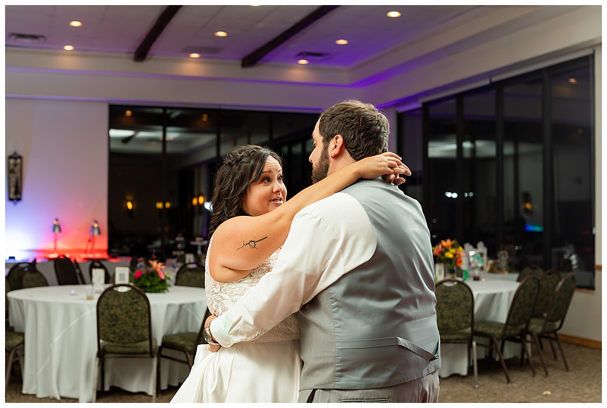 The couple shares their last dance in the ballroom of the Winter Park Mountain Lodge. There is no one else in the room and they have a private moment.