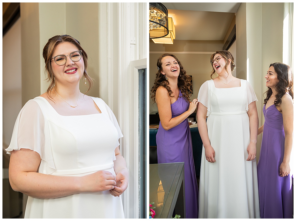 The bride gets ready with her two bridesmaids. She has brown hair in an updo and glasses. She is wearing a white wedding dress with flutter sleeves. her bridesmaids are wearing purple long dresses.