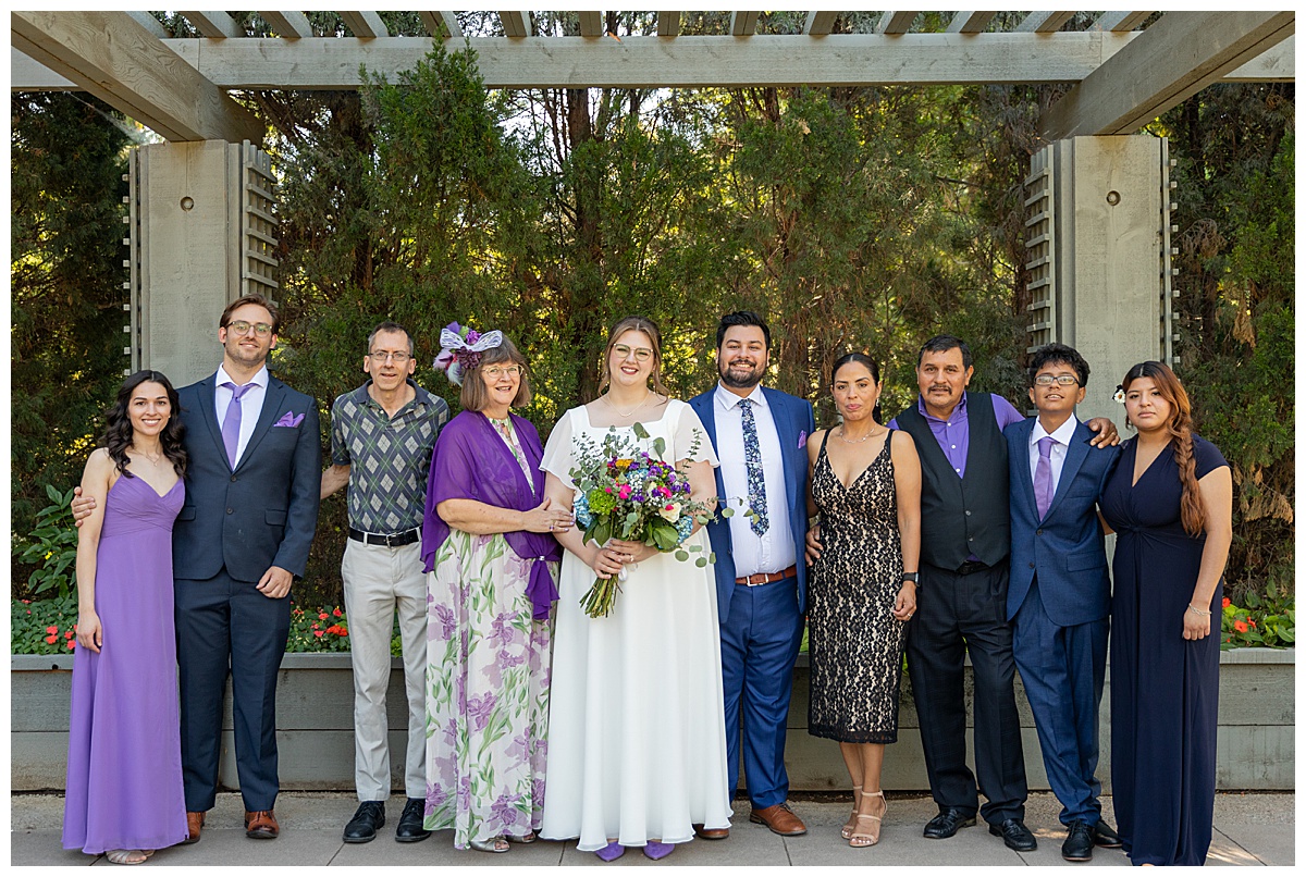 The bride and groom pose with their family after the ceremony. 