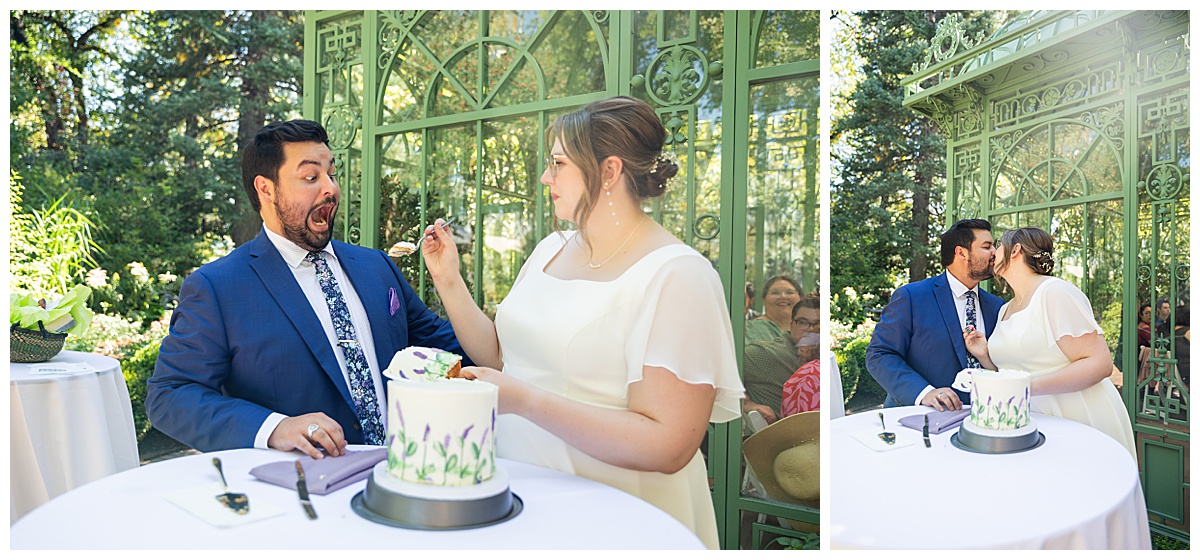 The bride and groom cut the cake outside of the green metal Woodland Mosaic Solarium. The cake is small with white icing; it has purple icing flowers with green stems and leaves on it.