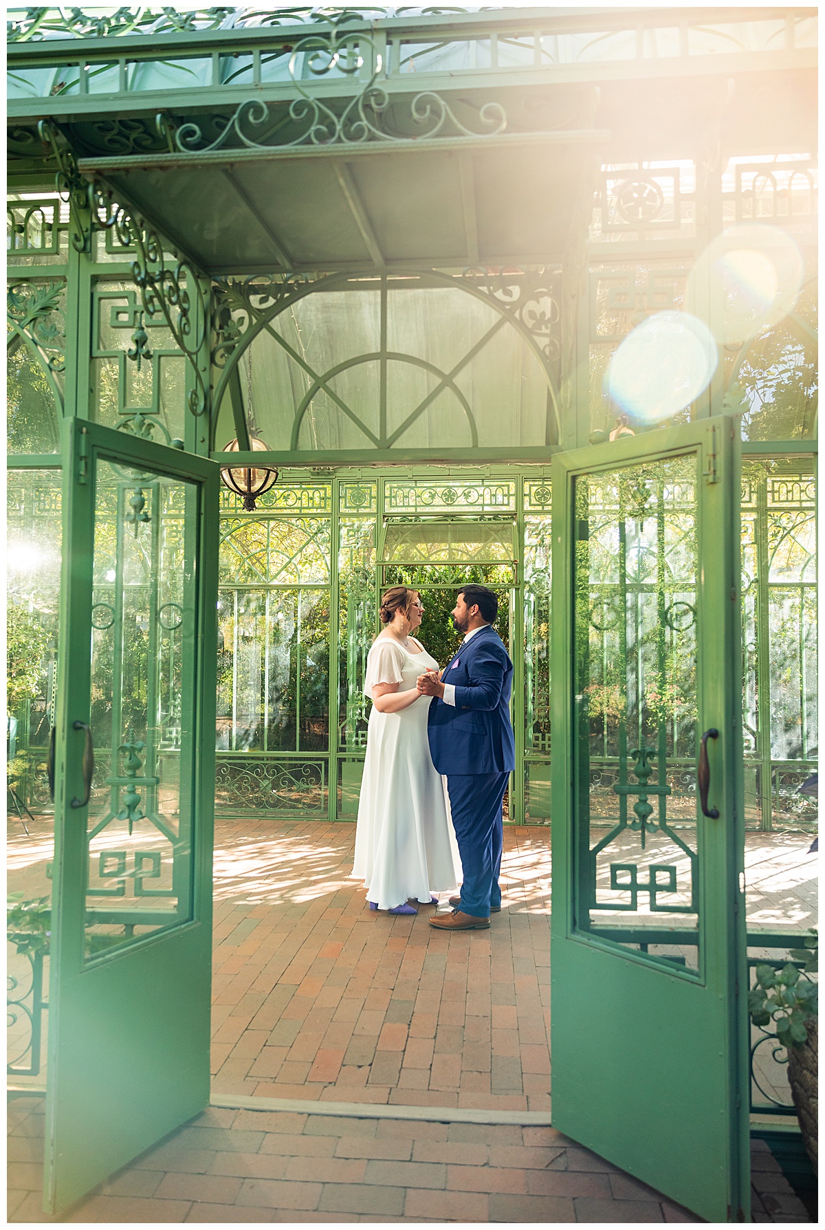 The bride and groom dance inside the green metal Woodland Mosaic Solarium. The solarium is empty now.