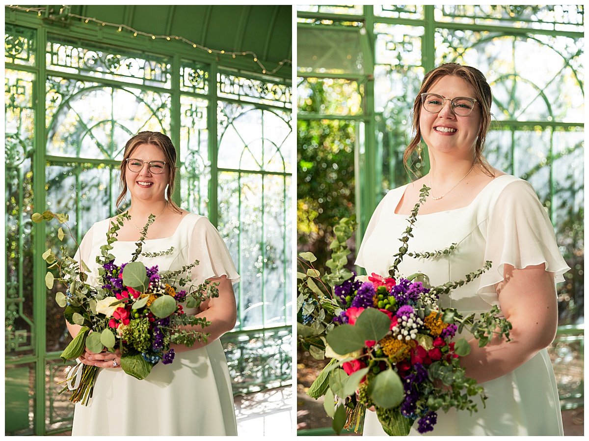 The bride smiles for her bridal portraits inside the green metal woodland mosaic solarium.