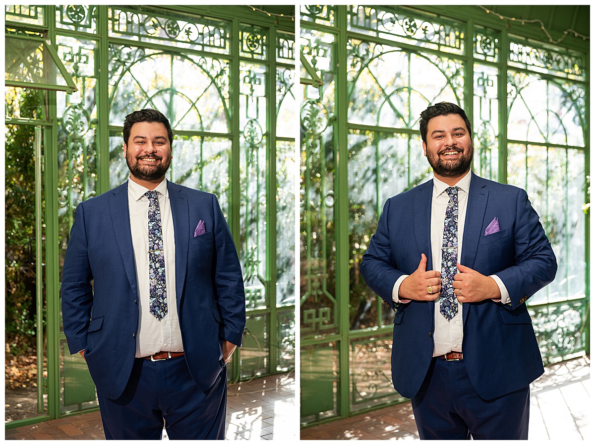 The groom smiles for his portraits inside the green metal woodland mosaic solarium.