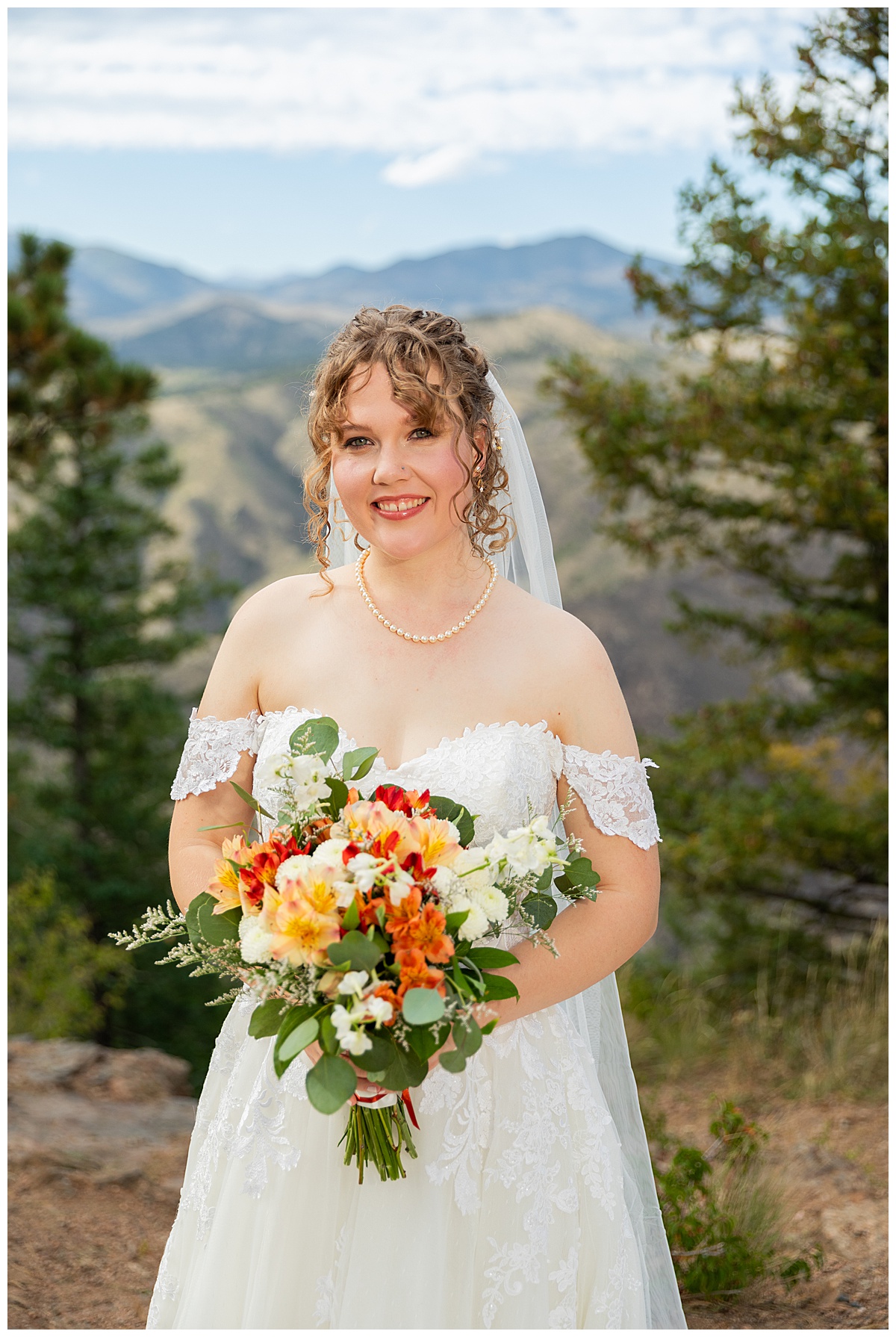 Photos of the bride and groom taking their bridal portraits for their Lookout Mountain wedding. They are posing in front of pine trees and the Rocky Mountain range in the background.