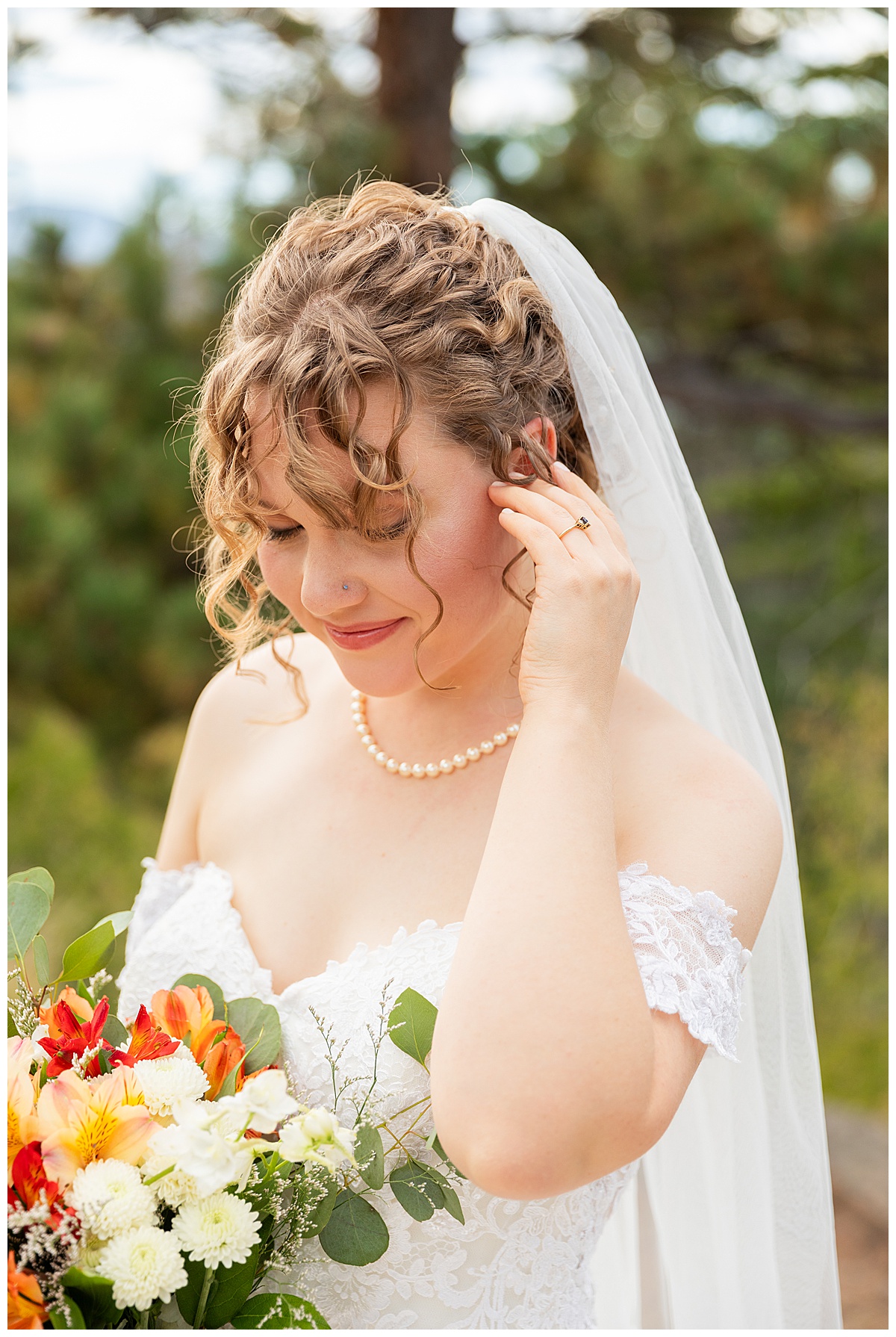 Photos of the bride and groom taking their bridal portraits for their Lookout Mountain wedding. They are posing in front of pine trees and the Rocky Mountain range in the background.