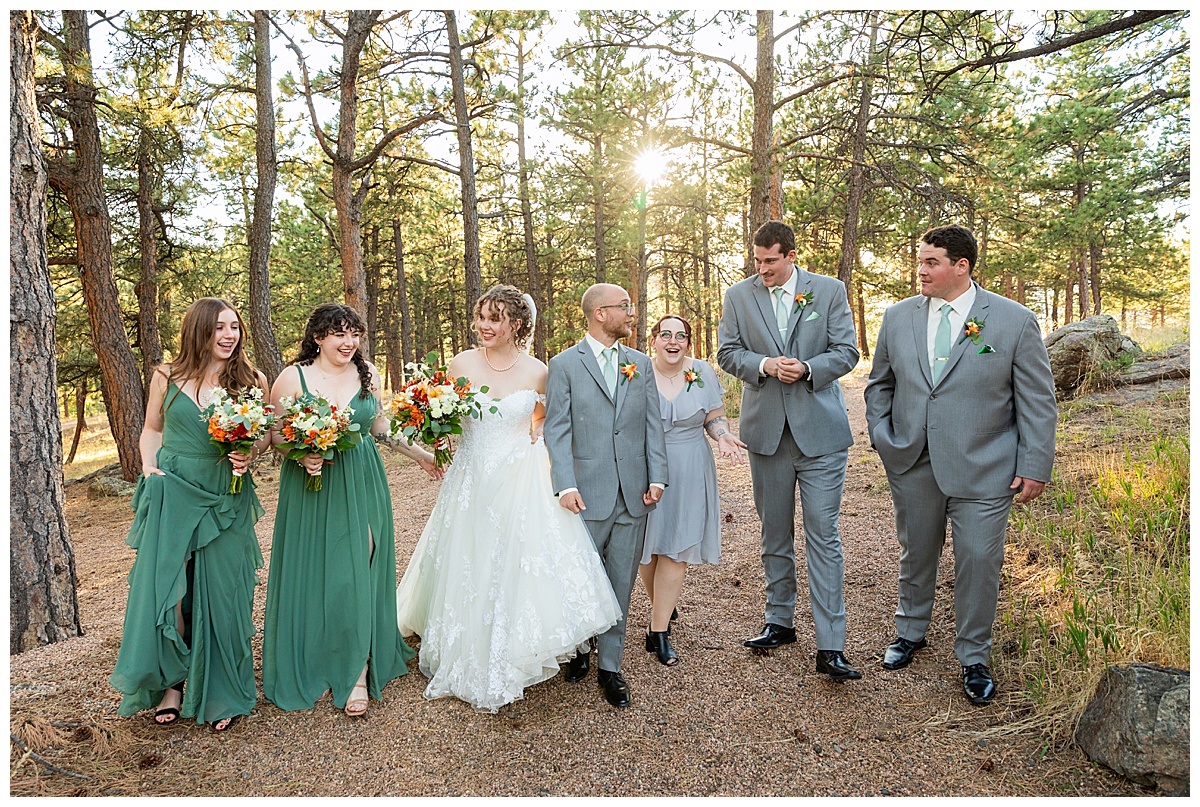 Photos of the bride and groom with their bridal party. The bride has two bridesmaids in floor-length green dresses. The groom has three groomsmen, one in a short gray dress and two in gray suits.